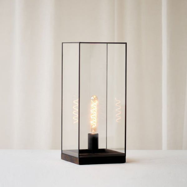 Askjer Table Lamp, black and delicately shaped. Sleek and stylish piece. It is a versatile piece that provides a touch of luxury in any home. Available at $280.